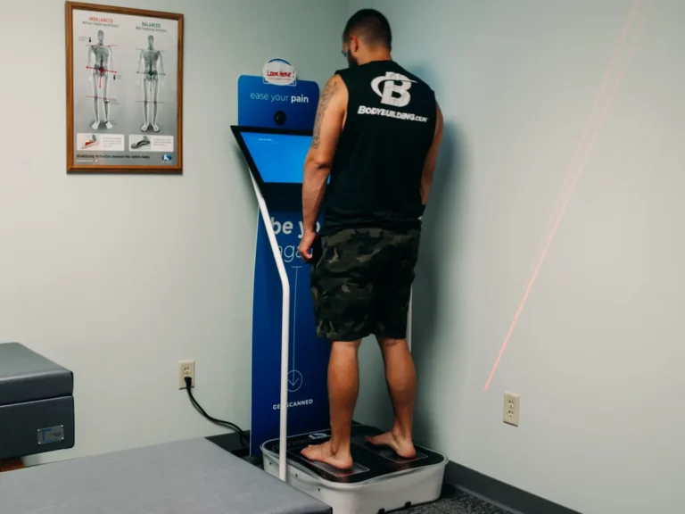 Patient standing on a 3D laser foot scanner for custom orthotics at Belden Village Chiropractic and Wellness Center in Canton, OH