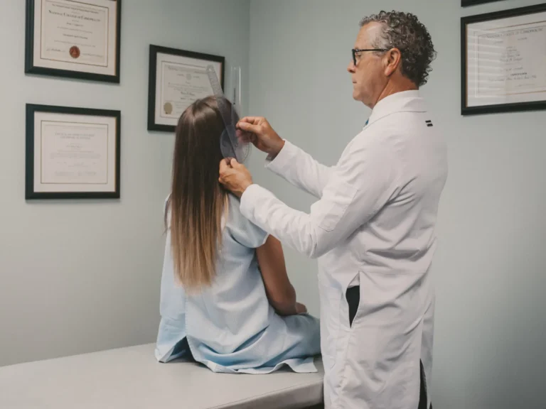 Dr. Brent Ungar measuring a patient’s neck range of motion during an exam at Belden Village Chiropractic and Wellness Center in Canton, OH