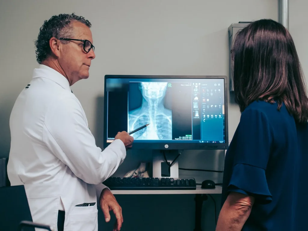 Dr. Brent Ungar reviewing a neck X-ray with a patient at Belden Village Chiropractic and Wellness Center in Canton, OH